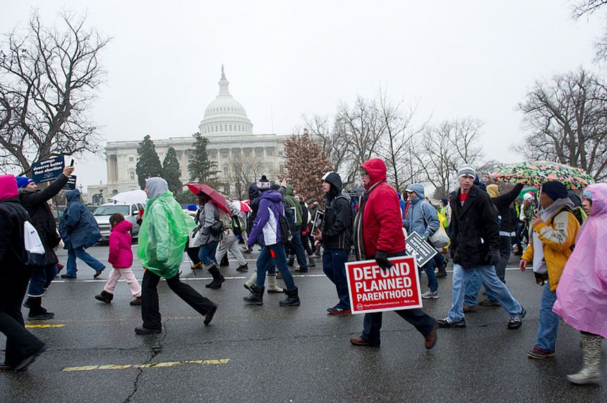 **FILE** Pro-life advocates march past the U.S. Capitol in Washington, D.C., on Monday, Jan. 23, 2012 as part of the March for Life. The group rallied at the National Mall and marched to the U.S. Supreme Court in hopes that Roe v. Wade will be overturned. (Barbara L. Salisbury/The Washington Times)