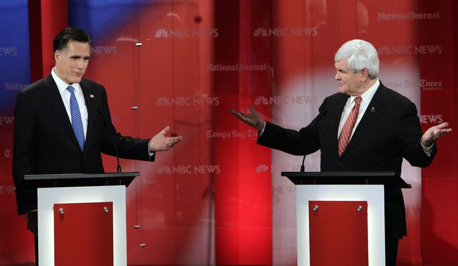 Former Massachusetts Gov. Mitt Romney (left) and former House Speaker Newt Gingrich gesture during a Republican presidential candidate debate on Monday, Jan. 23, 2012, at the University of South Florida in Tampa, Fla. (AP Photo/Paul Sancya)