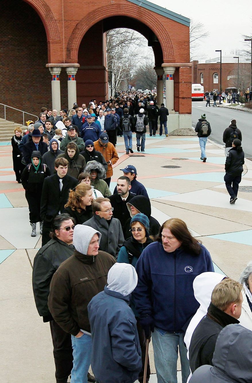 Mourners wait in line on campus Tuesday to view the casket of former Penn State head coach Joe Paterno, who died Sunday of lung cancer at age 85. (Associated Press)