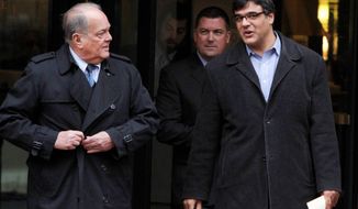 Former CIA officer John Kiriakou (right) and his attorneys, Plato Cacheris (left) and John Hundley, leave federal court Monday in Alexandria. In the latest criminal case in the Obama administration&#39;s effort to punish leakers, Mr. Kiriakou was charged Monday with disclosing classified secrets about his teammates to the media. (Associated Press)