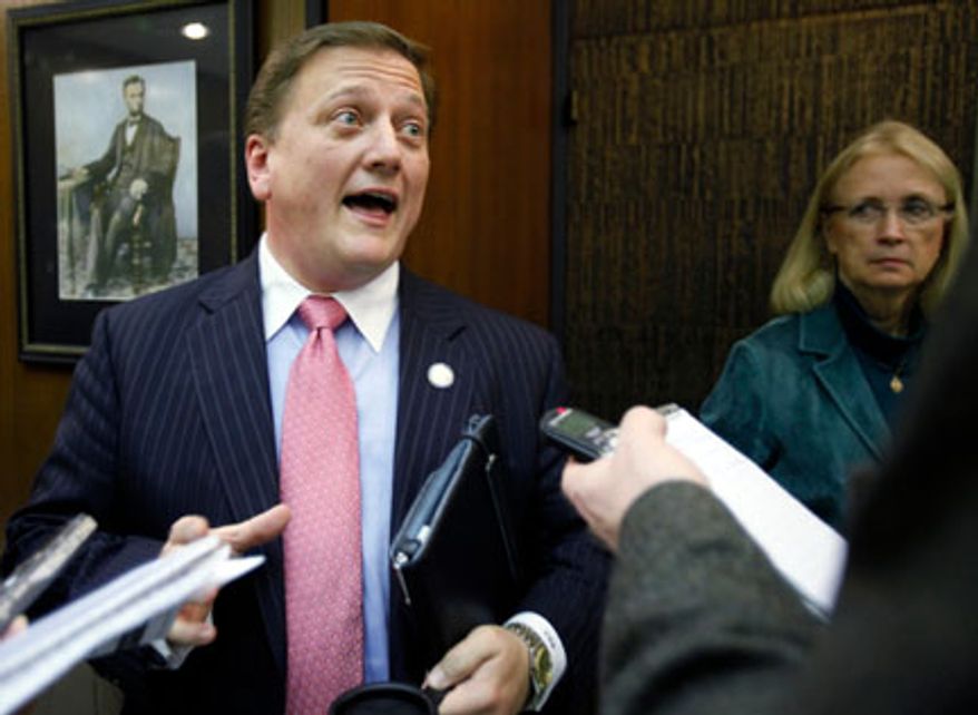Delegate Christopher T. Head, left, talks with reporters after the bill calling for drug testing of welfare recipients passed the House Health, Welfare and Institutions committee at the General Assembly Building in Richmond on Tuesday, Jan. 24, 2012. On the right, Del. Vivian E. Watts, D-Fairfax, walks past. (AP Photo/Richmond times-Dispatch, Bob Brown).