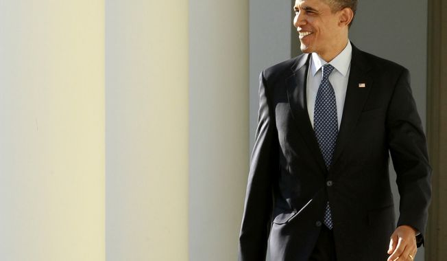 On the day of his State of the Union address, President Obama walks Jan. 24, 2012, from the Oval Office along the Colonnade of the White House. (Associated Press)