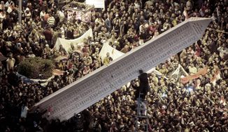 Egyptians set up an obelisk with the names of people who were killed during the 18-day uprising as they marked in Cairo&#x27;s Tahrir Square on Wednesday the first anniversary of the start of the revolt that forced President Hosni Mubarak from power. (Associated Press)