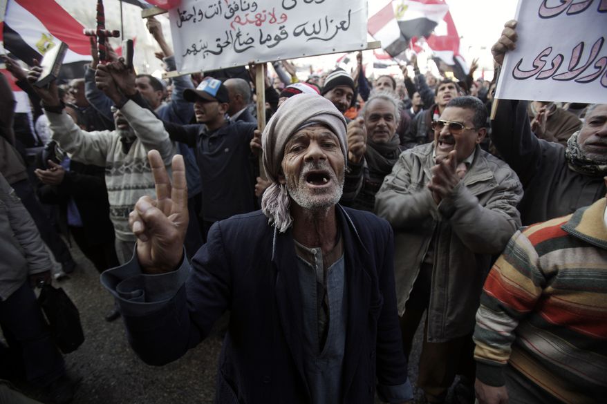 An Egyptian chants slogans as thousands gather in Tahrir Square in Cairo on Wednesday, Jan. 25, 2012, to mark the first anniversary of the uprising that ousted President Hosni Mubarak. (AP Photo/Muhammed Muheisen)