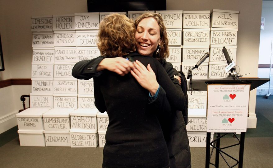 Ali Vanderzanden, with Equality Maine, hugs a friend before a Thursday news conference at the Statehouse in Augusta, Maine, at which a bid to legalize gay marriage in Maine was launched. (Associated Press)