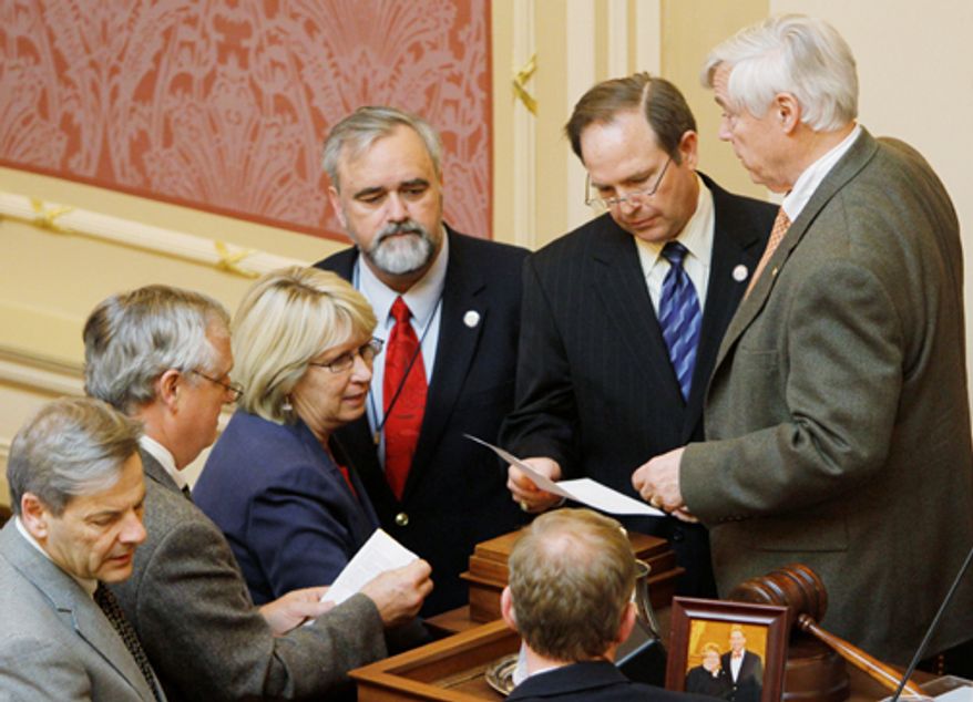 Virginia House Speaker William Howell (right) talks with Delegate Christopher Stolle (second from right) as Delegates Mark Cole (third from right), Kathy Byron (third from left), Robert Orrock (second from left) and David Toscano (left) discuss a bill that would end the state mandate for girls to receive the HPV vaccine during a House session at the Capitol in Richmond on Thursday, Jan. 26, 2012. (AP Photo/Steve Helber)