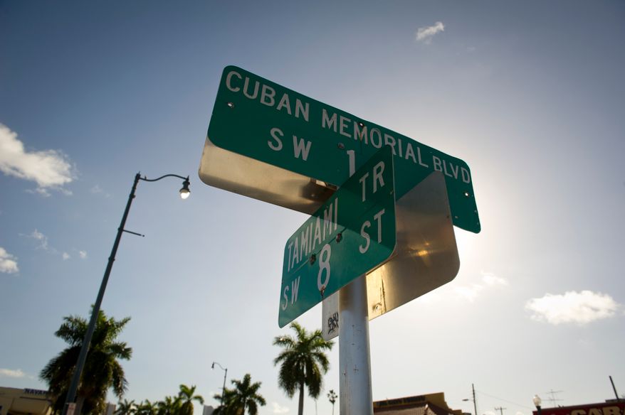 A street sign marks the intersection of Cuban Memorial Boulevard and Calle Ocho (Eighth Street) in the Little Havana neighborhood of Miami on Thursday, Jan. 26, 2012. (Rod Lamkey Jr./The Washington Times)