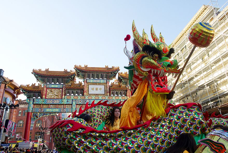 The New World Bilingual Institute's dragon makes its way under the Chinatown arch during the Chinese New Year Parade in Washington, D.C.,on Sunday, Jan. 29, 2012. (Barbara L. Salisbury/The Washington Times)