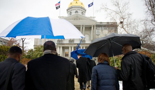 Washington Mayor Vincent C. Gray (center) arrives with D.C. Council members and D.C. citizens at the New Hampshire Statehouse in Concord, N.H., on Friday, Jan. 27, 2012, to try to gain support for D.C. statehood. (Andrew Harnik/The Washington Times)