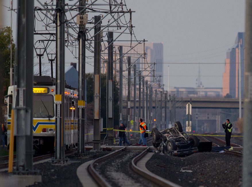 An SUV lies upside down on the tracks after being struck by a light-rail train in Sacramento, Calif., on Saturday, Jan. 28, 2012. (AP Photo/Jose Luis Villegas, Sacramento Bee)