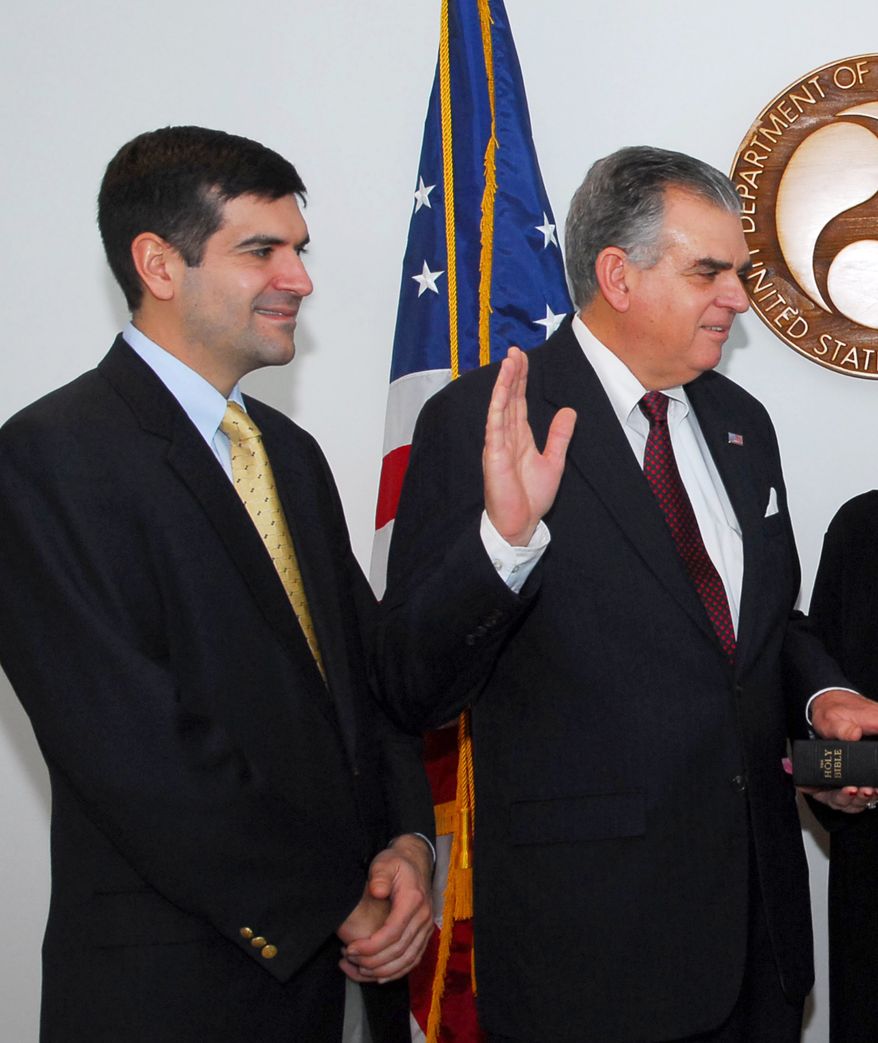 ** FILE ** Sam LaHood (left) looks on as his father, Ray LaHood, is sworn in as secretary of transportation in January 2009. (AP Photo/U.S. Department of Transportation)