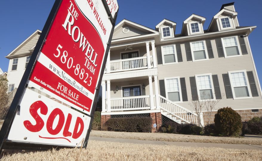 A real estate sign is displayed on Wednesday, Jan. 18, 2012, in front of a home in Little Rock, Ark. (Associated Press)