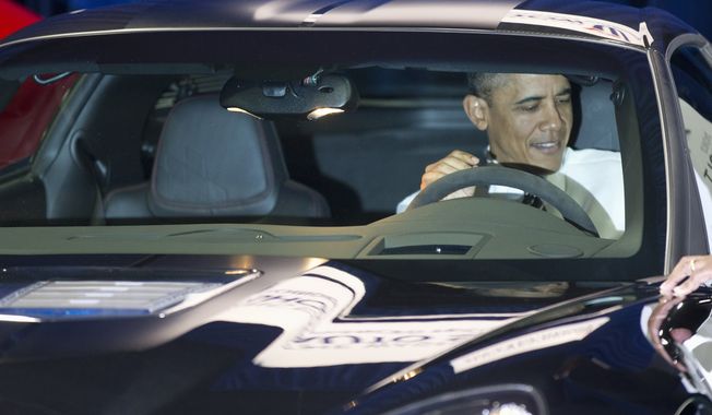 President Obama sits Jan., 31, 2012, inside a Chevrolet Corvette ZR1 during his visit to the Washington Auto Show at the Washington Convention Center in Washington. (Associated Press)