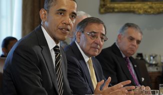 President Obama, sitting next to Defense Secretary Leon Panetta (center) and Transportation Secretary Raymond LaHood (right), speaks Jan. 31, 2012, during a cabinet meeting at the White House. (Associated Press)