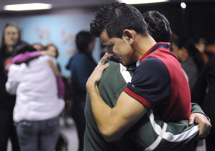 International Church of the Restoration parishioners in Marietta, Ga., mourn Jan. 30, 2012, the loss of Pastor Jose Carmo Jr., his wife Adriana and their daughter Leticia Carmo, who were killed the previous day in a multi-vehicle crash on Interstate 75 in Florida. (Associated Press)