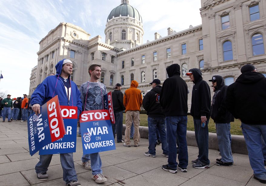 Union members protesting right-to-work legislation under consideration in the Indiana Senate wait to enter the Statehouse in Indianapolis on Wednesday, Feb. 1, 2012. (AP Photo/Michael Conroy)