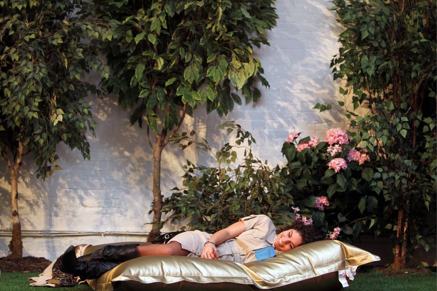 It's springtime in New York, at least in Park Here, a temporary indoor park in lower Manhattan where the temperature is a balmy 75 and recorded nature sounds play amid blossoming bushes. (Associated Press)