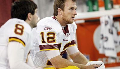 Washington Redskins quarterbacks Rex Grossman (8) and John Beck (12) sit on the bench during the second half of an NFLl game against the Buffalo Bills at the Rogers Centre in Toronto, Sunday, Oct. 30, 2011. (AP Photo/Derek Gee)