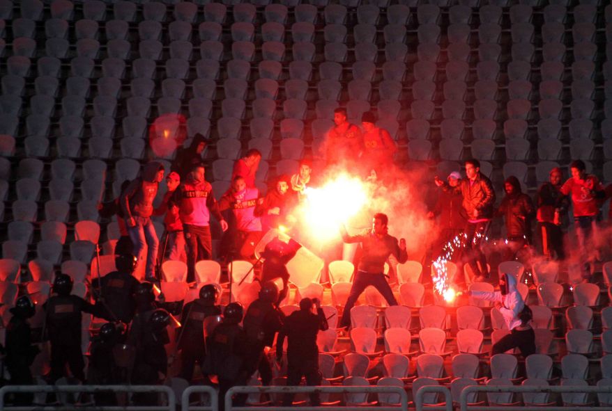 Soccer fans clash with riot police following a soccer match between the Al-Ahly and Al-Masry clubs at a stadium in Port Said, Egypt, on Wednesday, Feb. 1, 2012. (AP Photo)