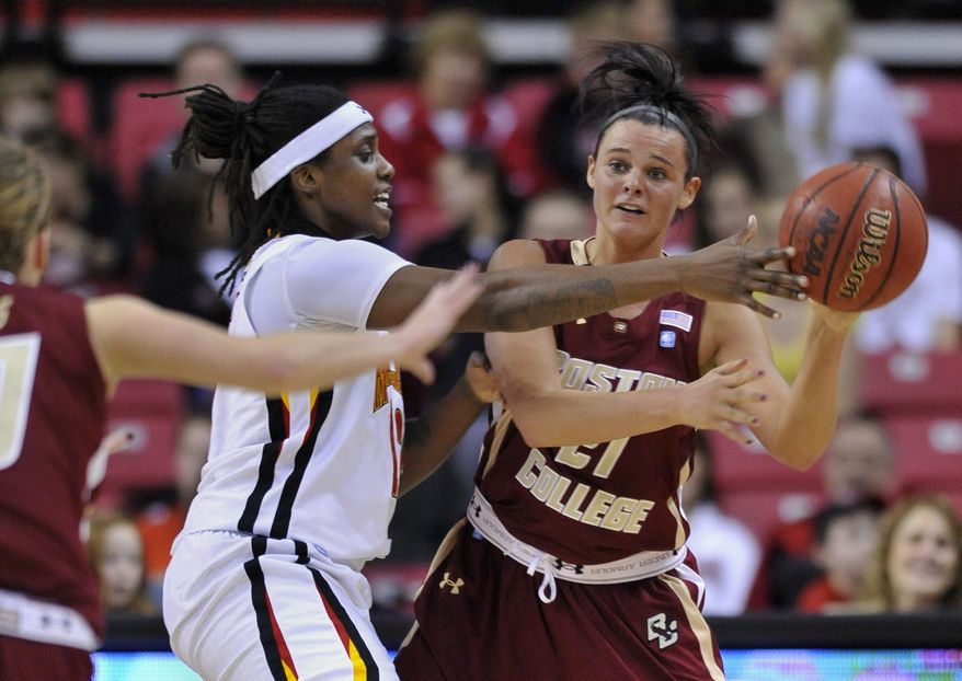 Boston College's Kristen Doherty, right, looks to pass under pressure from Maryland's Lynetta Kizer in the first half of an NCAA basketball game on Thursday, Feb. 2, 2012, in College Park, Md.(AP Photo/Gail Burton)