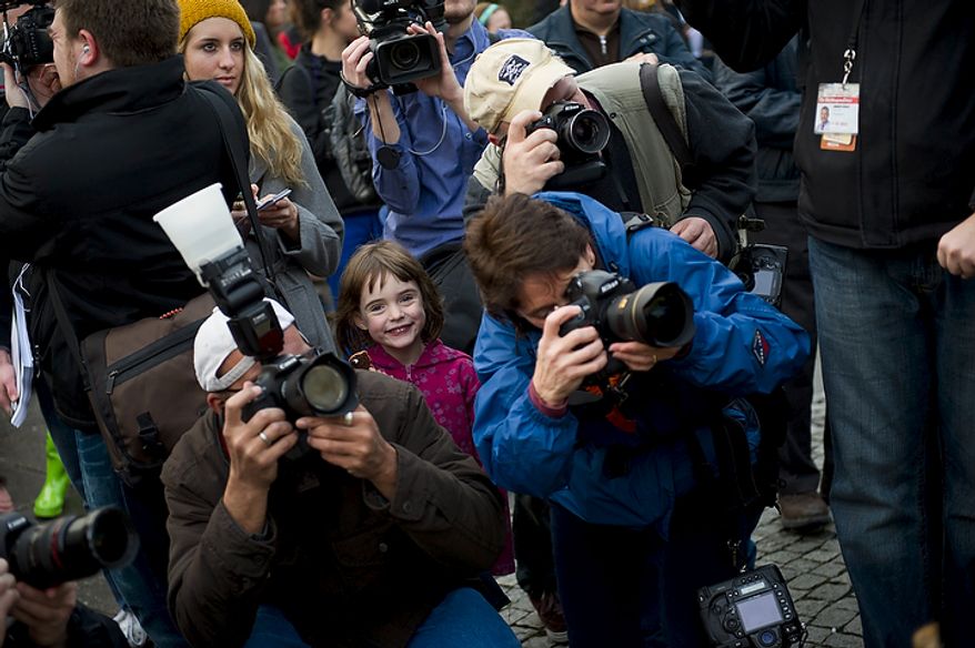 Ellen Lurie, 6, of Washington is sandwiched between news photographers and reporters during the inaugural Groundhog Day event at Dupont Circle in Washington on Thursday, Feb. 2, 2012. (Rod Lamkey Jr./The Washington Times)