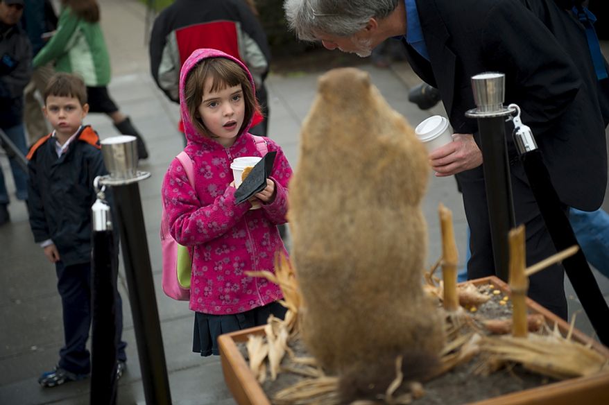 Ellen Lurie (center), 6, and her twin brother, Jonathan (left), join their father, Peter Lurie of Washington, at the inaugural Groundhog Day event at Dupont Circle in Washington on Thursday, Feb. 2, 2012. (Rod Lamkey Jr./The Washington Times)