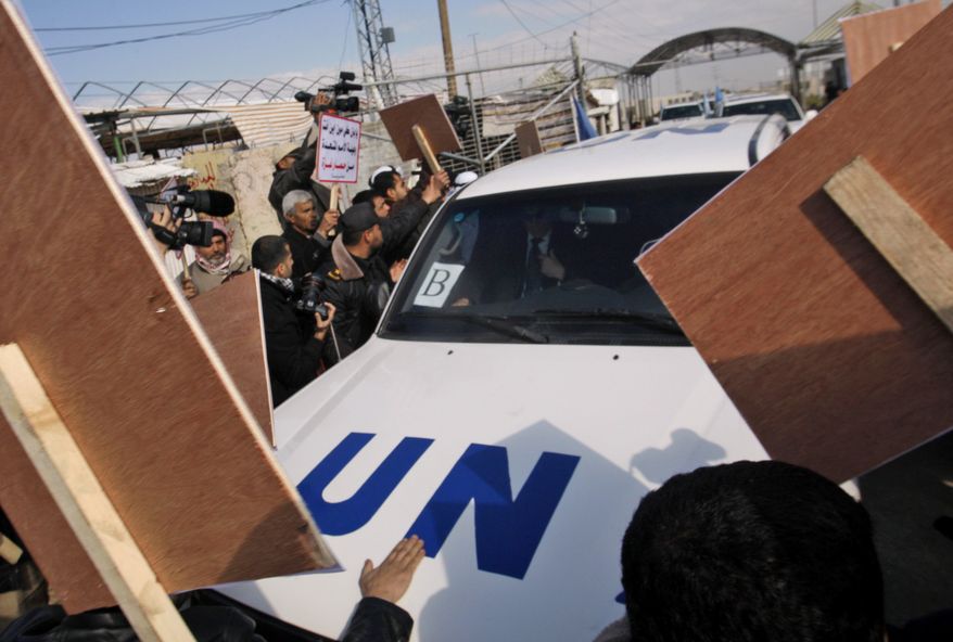 Palestinian demonstrators surround the convoy of U.N. Secretary-General Ban Ki-moon as it enters the Erez border crossing between Israel and Gaza on Thursday, Feb. 2, 2012. (AP Photo/Hatem Moussa)
