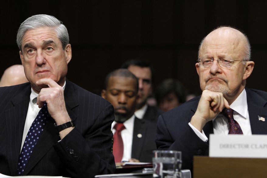 FBI Director Robert S. Mueller III (left) and Director of National Intelligence James R. Clapper testify on Capitol Hill in Washington on Tuesday, Jan. 31, 2012, at a Senate Intelligence Committee hearing to assess current and future national security threats. (AP Photo/Jacquelyn Martin)