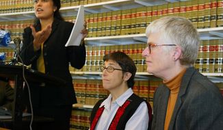 ** FILE ** Jayashri Srikantiah, staff attorney with the ACLU of Northern California, holds up copies of records showing passengers checked on no-fly lists from San Francisco International Airport, as plaintiffs Jan Adams, right, and Rebecca Gordon, center, look on during a news conference in San Francisco, in this April 22, 2003, file photo. (AP Photo/Eric Risberg, File)