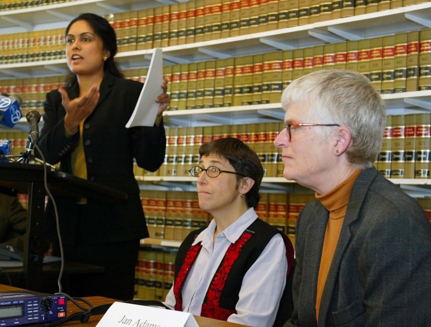 ** FILE ** Jayashri Srikantiah, staff attorney with the ACLU of Northern California, holds up copies of records showing passengers checked on no-fly lists from San Francisco International Airport, as plaintiffs Jan Adams, right, and Rebecca Gordon, center, look on during a news conference in San Francisco, in this April 22, 2003, file photo. (AP Photo/Eric Risberg, File)