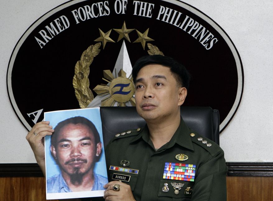 Col. Arnulfo Marcelo Burgos, a spokesman for the Philippine military, shows a picture of Malaysian Zulkipli bin Hir, also known as Marwan, a top leader of the regional, al-Qaeda-linked Jemaah Islamiyah terror network, during a press conference on Thursday, Feb. 2, 2012, in Quezon City, Philippines, north of Manila. (AP Photo/Pat Roque)
