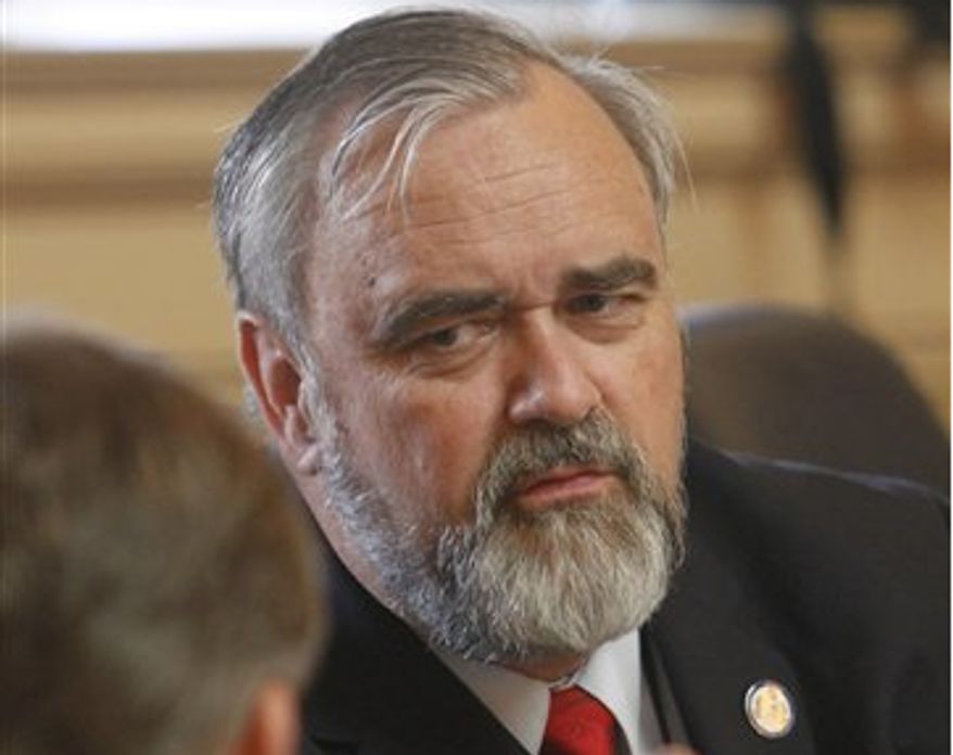 Delegate Mark Cole, Spotsylvania Republican, listens to a fellow delegate during the House session at the Capitol in Richmond, Va., Tuesday, Jan. 31, 2012. (AP Photo/Steve Helber)