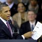 President Barack Obama holds up a proposed mortgage application form as he speaks at the James Lee Community Center in Falls Church, Va., Wednesday, Feb. 1, 2012. (AP Photo/Cliff Owen)