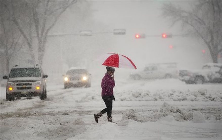 Kayma Pence walks along N street during a snowstorm in Lincoln, Neb. on Saturday, Feb. 4, 2012. A winter storm warning was issued for parts of western Nebraska and northeastern Kansas and into southwestern Iowa. A band of heavy snow stalled over Nebraska, dumping nearly 13 inches in some spots. (AP Photo/The Journal-Star, Jacob Hannah)