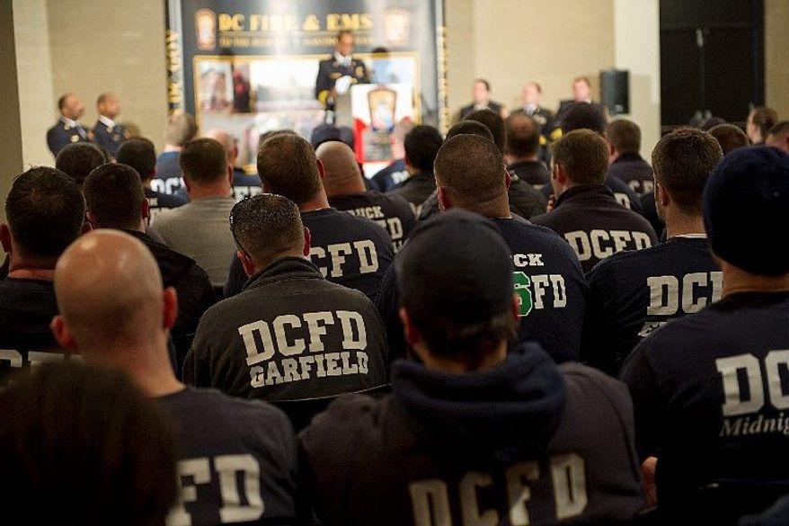 Firefighters listen to Chief Kenneth Ellerbe's State of the Department speech Jan. 24, at the Martin Luther King Jr. Memorial Library. About 100 walked out to protest shift and uniform changes. A spokesman has used social media to call their actions racist. (Barbara L. Salisbury/The Washington Times)