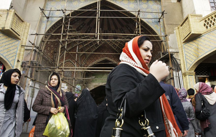 Iranians walk Feb. 2, 2012, at Tehran's old main bazaar. A simple trip the store these days offers a crash course in life under sanctions. The price tags on many imported goods are sometimes double from 2011. The money to buy them, meanwhile, has plunged in value against the U.S. dollar and other foreign currencies. (Associated Press)