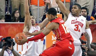 Maryland&#39;s Terrell Stoglin (12) drives the lane between Clemson&#39;s Milton Jennings, left, and Devin Booker in the second half of an NCAA college basketball game against Clemson on Tuesday, Feb. 7, 2012 in Clemson, S.C. (AP Photo/Anderson Independent-Mail, Mark Crammer) GREENVILLE NEWS, SENECA JOURNAL - OUT