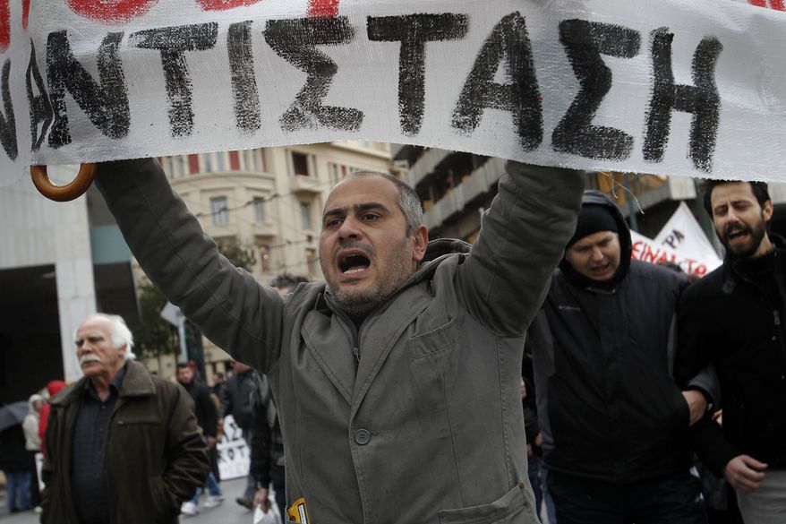 A Greek protester holds a banner with the word "resistance'' during a 24-hour strike in Athens on Tuesday, Feb. 7, 2012. (AP Photo/Petros Giannakouris)