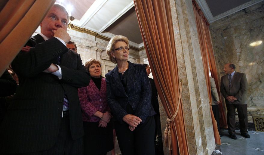 Gov. Chris Gregoire, right, looks on at a House floor debate on gay marriage with Sen. Ed Murray, left, and Sen. Lisa Brown from the wings Wednesday, Feb. 8, 2012, in Olympia, Wash. Lawmakers legalized gay marriage in Washington state, making it the seventh state in the nation to allow same-sex couples to wed. Democratic Gov. Gregoire is likely to sign the bill next week. (AP Photo/Elaine Thompson)