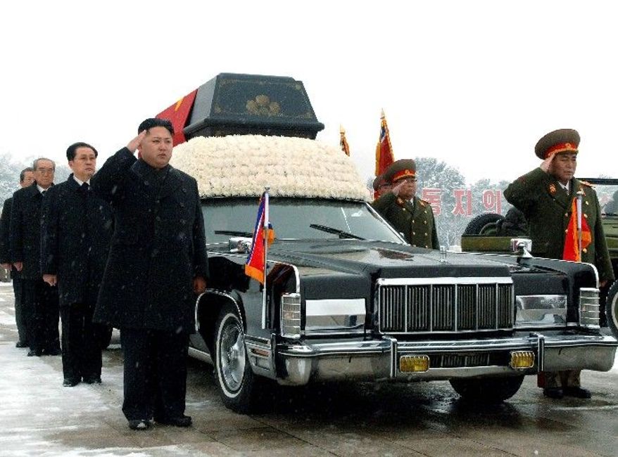 Kim Jong-un (left) salutes beside the hearse carrying the body of his late father and North Korean leader Kim Jong-il during the funeral procession in Pyongyang, North Korea, on Dec. 28. Behind the new leader is his uncle Jang Song-thaek, who is vice chairman of the National Defense Commission. Behind Mr. Jang is top propaganda official Kim Ki-nam and then Workers' Party official Choe Thae-bok (far left, partially hidden). The two military officers are Ri Yong-ho, vice marshal of the Korean People's Army (front right), and People's Armed Forces Minister Kim Yong-chun. (Associated Press)