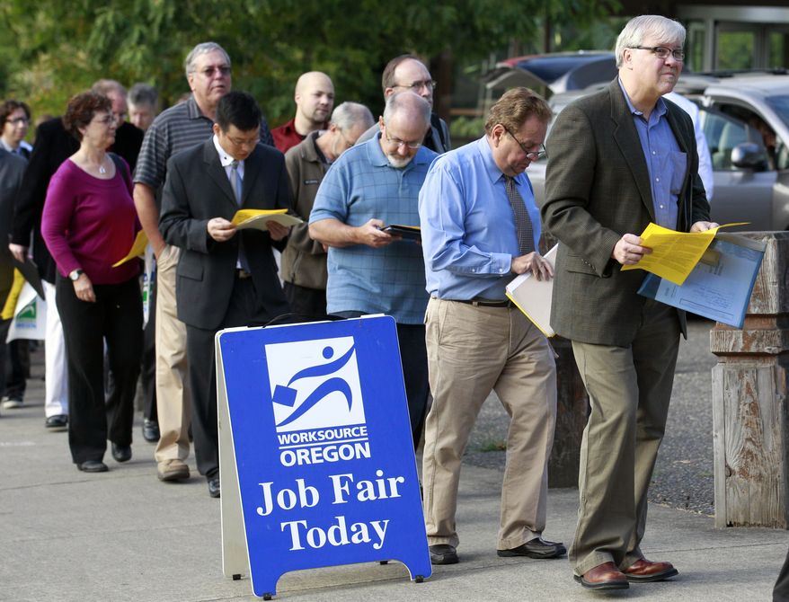 **FILE** People wait in line Sept. 15, 2011, at the Maximum Connections Job and Career Fair in Portland, Ore. (Associated Press)