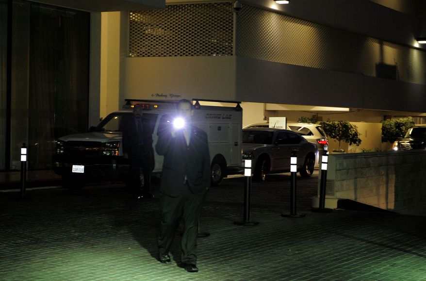 Security gather outside the Beverly Hilton Hotel Saturday Feb. 11, 2012 in Beverly Hills Calif. Whitney Houston, who ruled as pop music's queen until her majestic voice and regal image were ravaged by drug use, erratic behavior and a tumultuous marriage to singer Bobby Brown, died Saturday, Feb. 11, 2012. She was 48.(AP Photo/Mark J. Terrill)