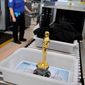 A genuine Oscar statue awaits its security check at O&#39;Hare International Airport in Chicago before its flight to Los Angeles. (Associated Press)