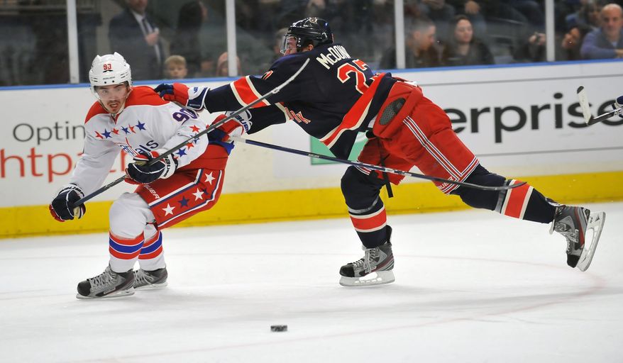 New York Rangers&#39; Ryan McDonagh pushes Washington Capitals&#39; Marcus Johansson off the puck during the first period of an NHL game Sunday, Feb. 12, 2012, in New York. (AP Photo/Newsday, David Pokress)