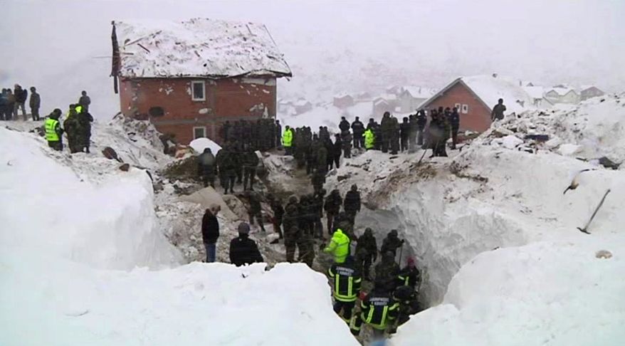 Rescuers clear snow and rubble from a house flattened by an avalanche in Restelica, Kosovo, on Sunday, Feb. 12, 2012. (Associated Press Television News)