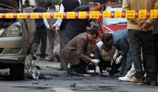 Indian security and forensic officials examine the spot where a bomb blew up an Israeli Embassy car. The attack was similar to ones on Iranian nuclear scientists. (Associated Press)