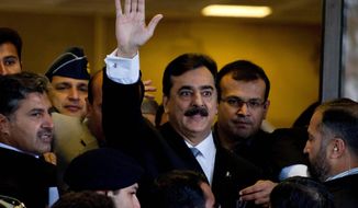 Pakistani Prime Minister Yousuf Raza Gilani arrives at the Supreme Court for a hearing in Islamabad on Monday. Judges charged Mr. Gilani with contempt for defying their orders to reopen an old corruption case against his political ally, President Asif Ali Zardari. (Associated Press)