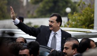 Pakistani Prime Minister Yousuf Raza Gilani waves upon his arrival at the Supreme Court in Islamabad, Pakistan, on Monday, Feb. 13, 2012. The court charged Mr. Gilani with contempt for defying its orders to reopen an old corruption case against his political ally, President Asif Ali Zardari. (AP Photo/B.K. Bangash)