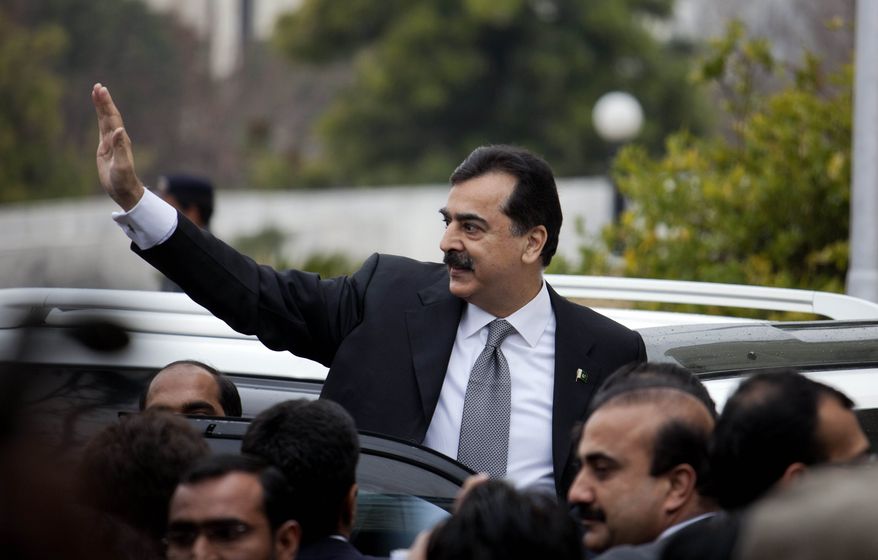 Pakistani Prime Minister Yousuf Raza Gilani waves upon his arrival at the Supreme Court in Islamabad, Pakistan, on Monday, Feb. 13, 2012. The court charged Mr. Gilani with contempt for defying its orders to reopen an old corruption case against his political ally, President Asif Ali Zardari. (AP Photo/B.K. Bangash)