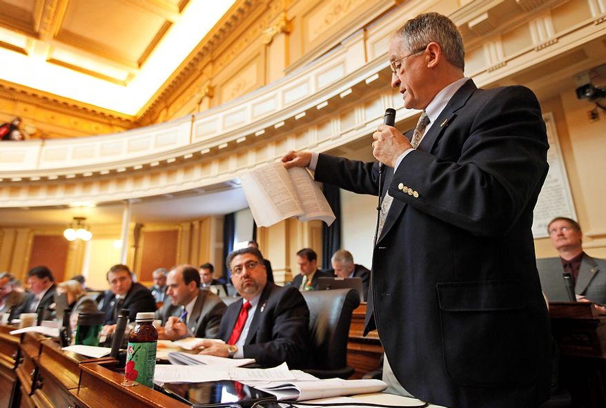 Delegate Robert G. Marshall holds a book as he reads to the House during debate on a bill defining life at the moment of conception during the House session at the Capitol in Richmond, Va., Monday, Feb. 13, 2012. (AP Photo/Steve Helber)